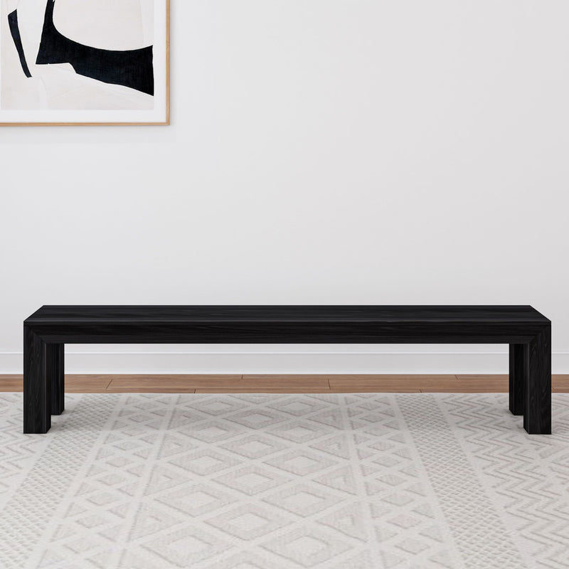 Modern black wooden bench in minimalistic living room with abstract wall art.