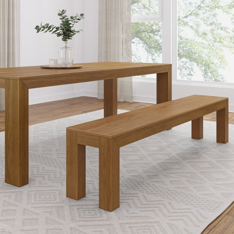Wooden dining table and bench set in a modern living room with natural light and greenery.