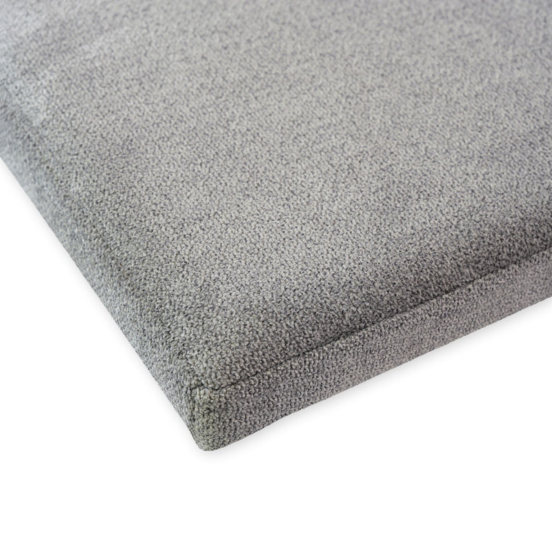 Gray textured seat cushion upholstery close-up.