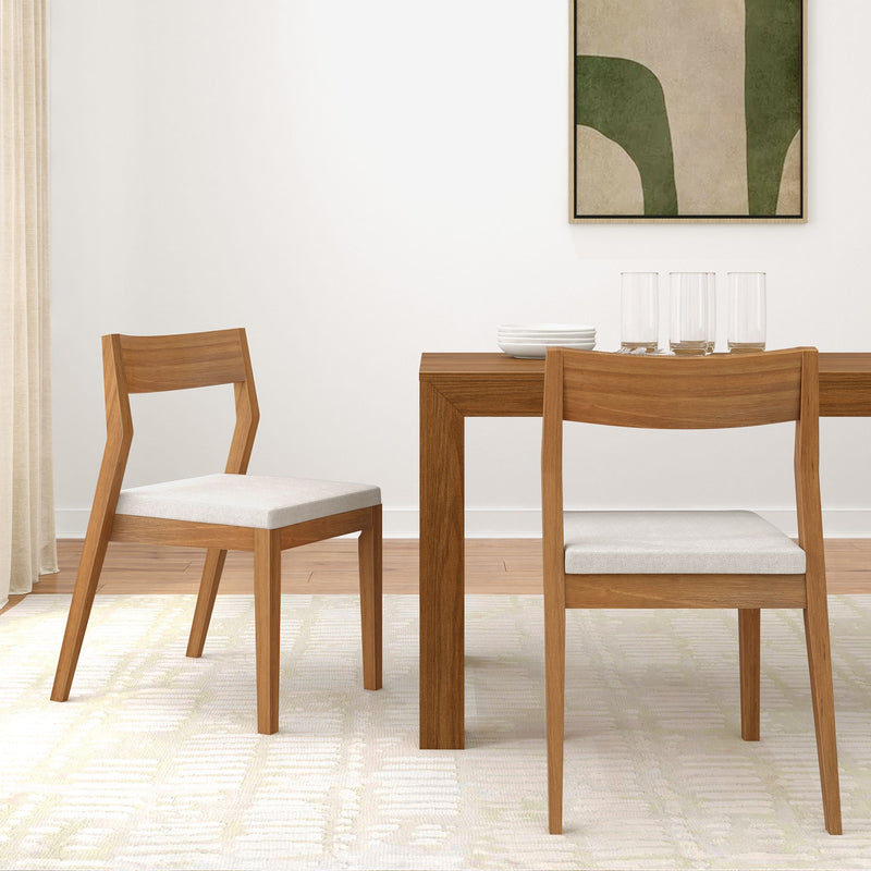 Modern wooden dining room set with minimalist chairs and a table, accented by a geometric wall art piece.