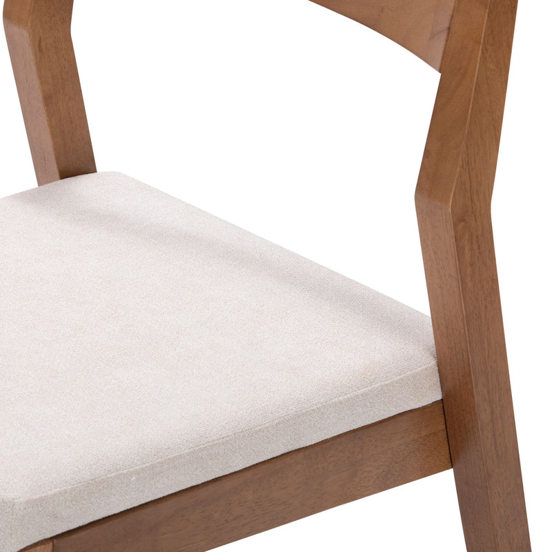 Wooden dining chair with cream upholstered seat cushion.
