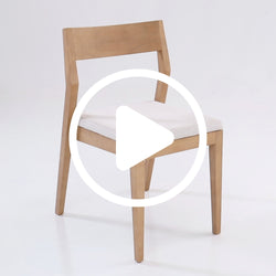 Wooden dining chair with white upholstered seat on a plain background.