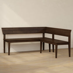 Dark walnut L-shaped wooden bench with backrest and tapered legs in dining nook on light hardwood floor