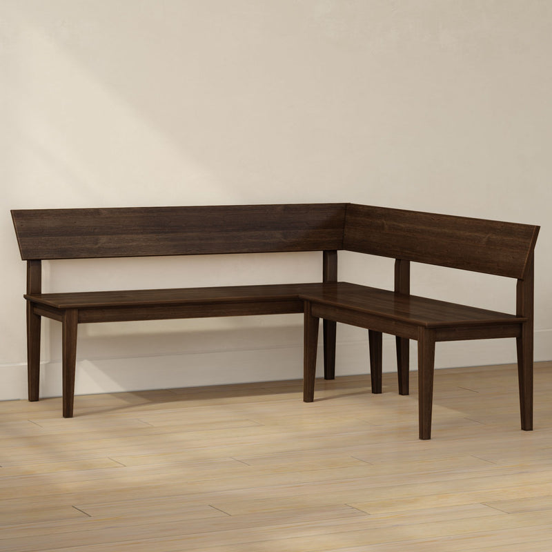 Dark walnut L-shaped wooden bench with backrest and tapered legs in dining nook on light hardwood floor