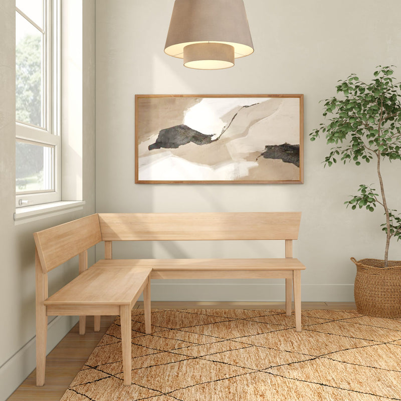 Modern Scandinavian entryway with light wood L-shaped corner bench, neutral abstract wall art, woven jute rug, pendant light and potted indoor plant