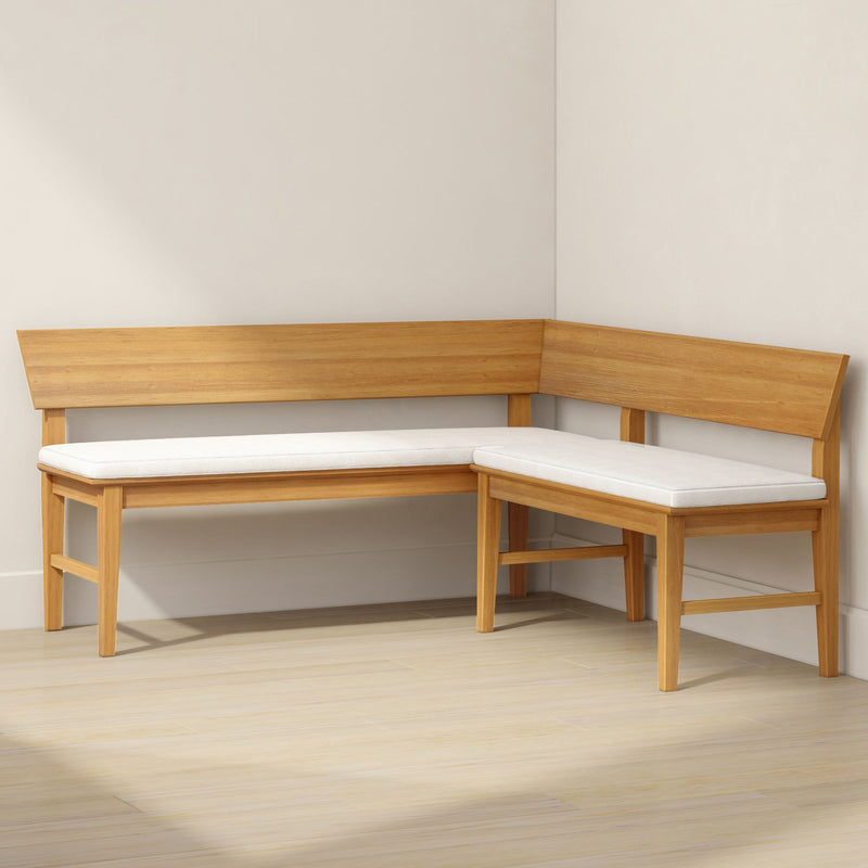 Modern oak corner bench with white upholstered cushions in a minimalist dining nook — space-saving wooden breakfast-nook seating