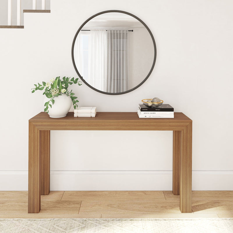 Wooden console table with decorative mirror and potted plant in a modern hallway.