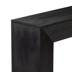 Close-up of black-stained oak fireplace mantel corner showing wood grain texture and modern rectangular shelf