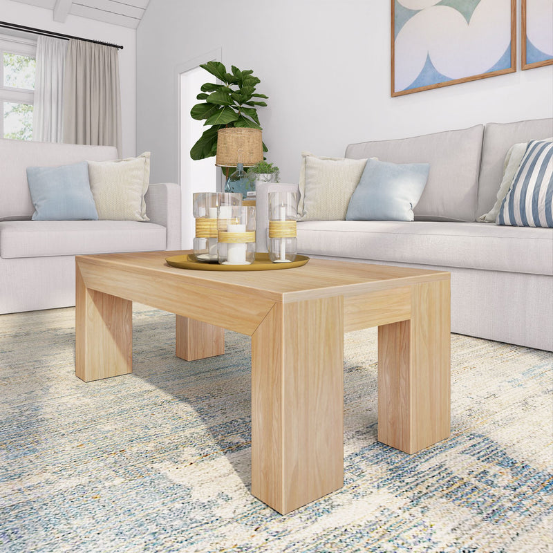 Modern living room with wooden coffee table, candles, and cozy sofas.