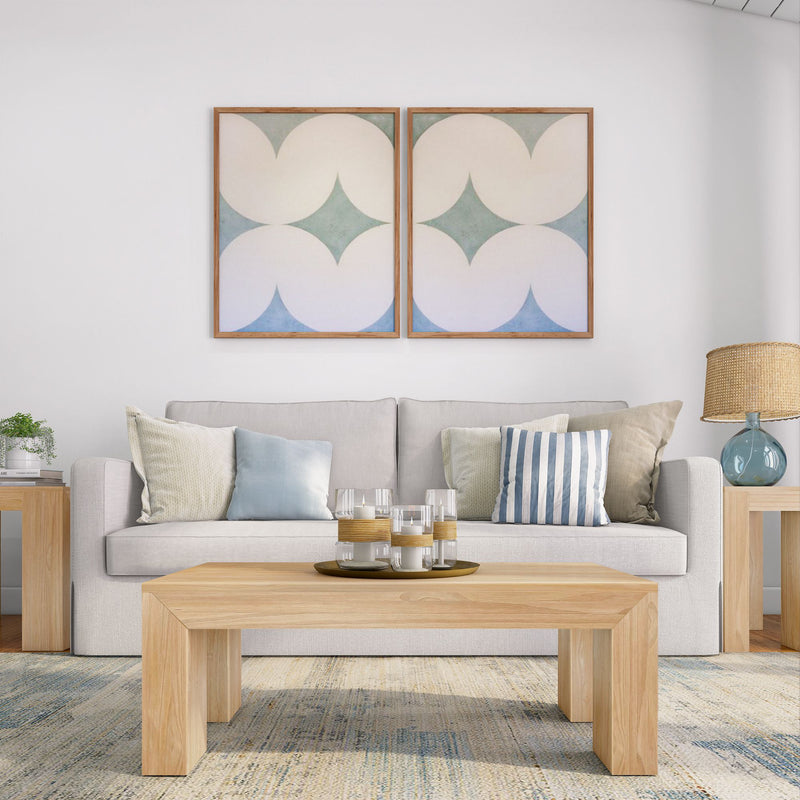 Modern living room with beige sofa, wooden coffee table, geometric wall art, and decorative pillows.