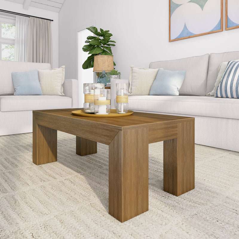 Modern living room with beige sofas, wooden coffee table, decorative candles, and indoor plant for cozy home decor.