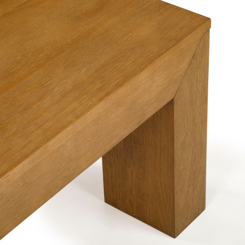 Close-up of a modern wooden table corner with a sleek oak finish.