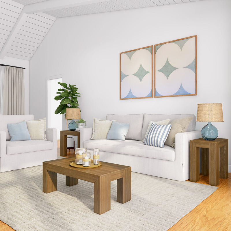 Modern minimalist living room with white sofas, wooden coffee table, and abstract art on the wall.