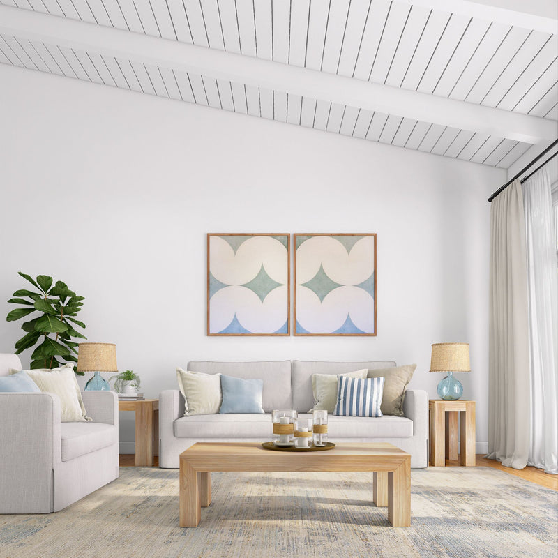 Modern living room with neutral decor, beige sectional sofa, abstract wall art, and indoor plant.