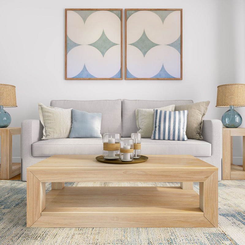 Stylish modern living room with beige sofa, decorative pillows, wooden coffee table, and artistic wall decor.