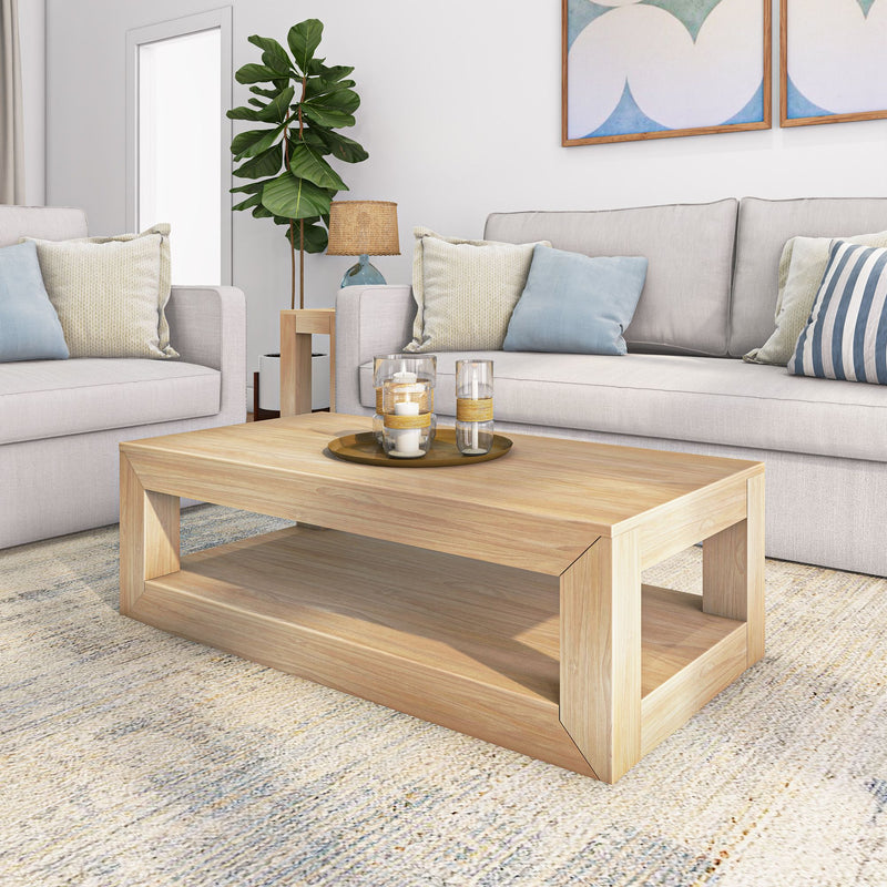 Stylish modern living room with beige sofas, light wood coffee table, decorative pillows, and indoor plants.