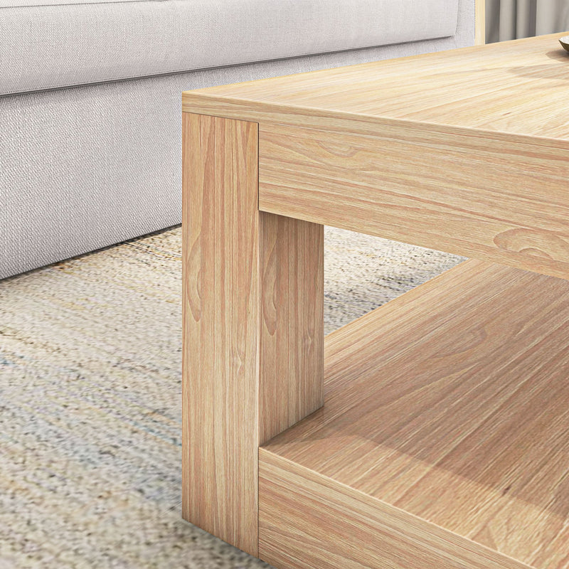 Modern wooden coffee table with beige sofa in living room setting.