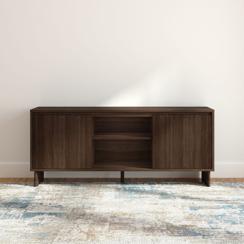 Mid-century modern dark walnut media console sideboard with open shelving and sliding cabinet doors on a patterned area rug in a minimalist living room