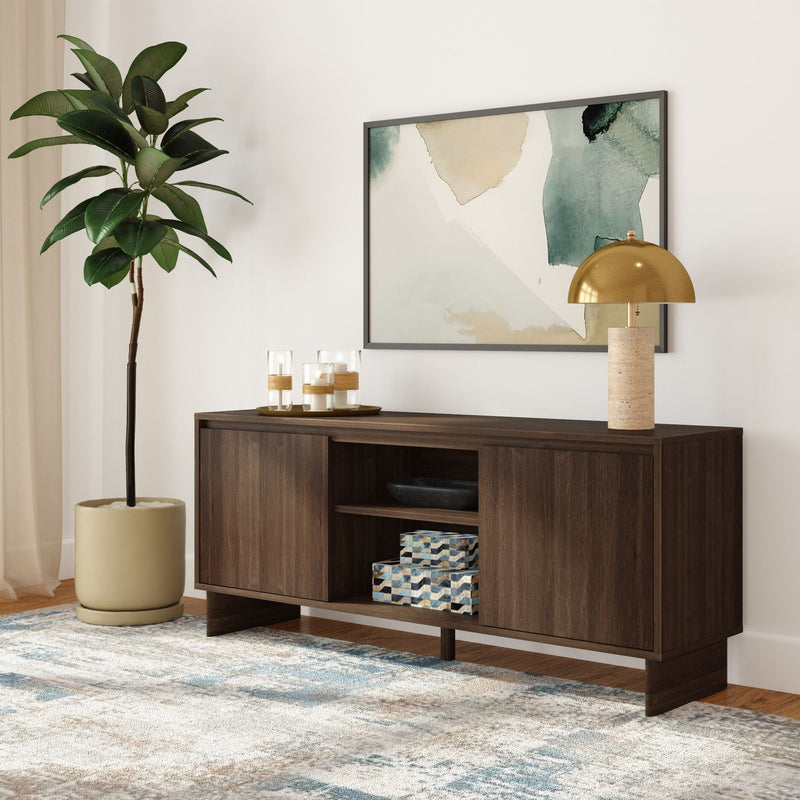 Dark wood console table with storage cabinet, gold dome table lamp, abstract wall art, potted fiddle leaf fig and patterned rug in modern living room