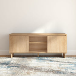 Minimalist light oak sideboard console with sliding doors and open shelving on blue-beige area rug