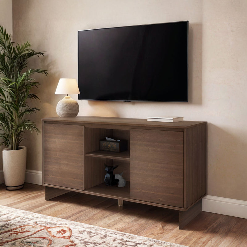 Modern wooden media console under wall-mounted flat-screen TV with lamp, potted plant and hardwood floor in cozy living room