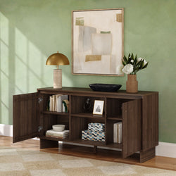 Dark wood console cabinet with open shelving and doors in living room, styled with gold table lamp, abstract wall art, vase of white flowers and decorative boxes