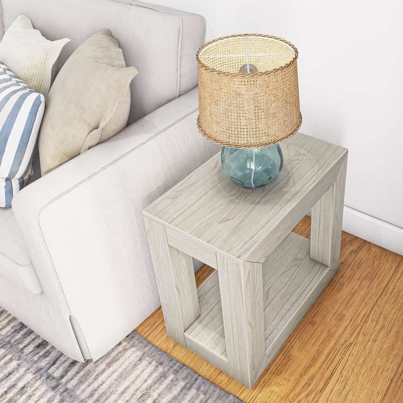 Cozy living room setup featuring a beige sofa with decorative pillows, a modern wooden side table, and a stylish wicker lampshade, perfect for a contemporary home decor.