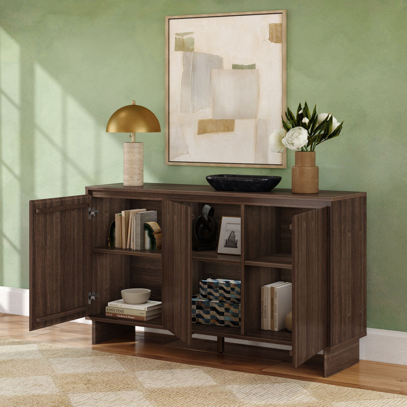 Dark walnut modern sideboard/console cabinet with open doors revealing shelves of books and decor, topped with a gold dome lamp, black bowl and vase of white flowers beneath abstract wall art in a green-walled living room