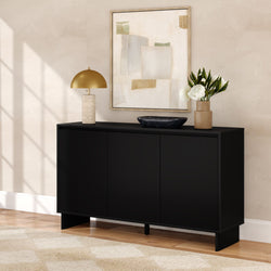 Modern black console sideboard storage cabinet in a neutral living room with a gold dome table lamp, abstract beige wall art, black marble bowl and a vase of white flowers on hardwood flooring