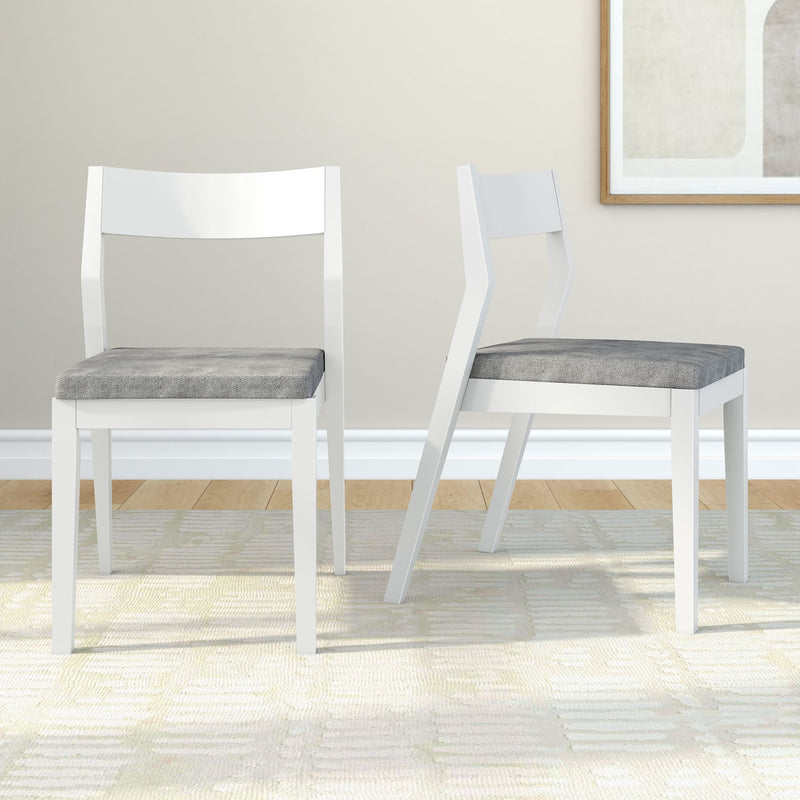 Modern white wooden chairs with grey cushions on a light patterned rug.