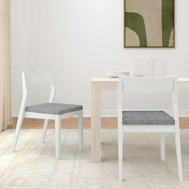 Modern dining room with white chairs and light wood table, minimalist decor.