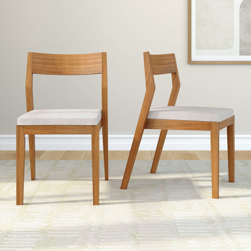 Set of two modern wooden dining chairs with beige cushions in a contemporary living room setting.