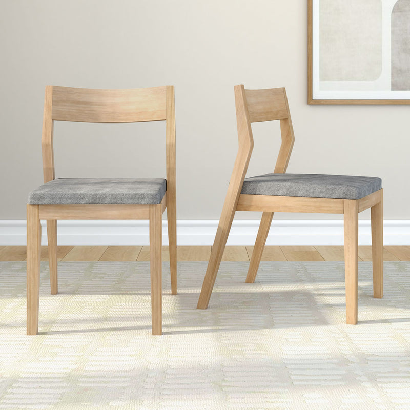 Modern wooden dining chairs with gray cushions on a light carpet, perfect for contemporary home decor.