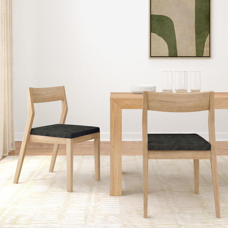Modern dining room with wooden table, black cushioned chairs, and minimalist decor.