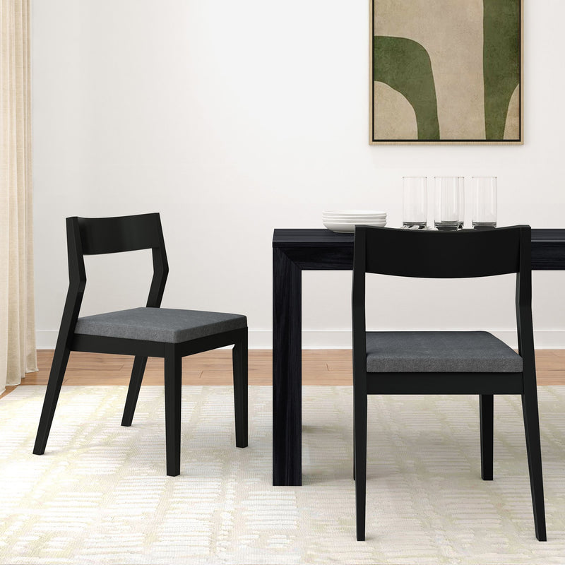 Modern dining room with black chairs and minimalist decor.