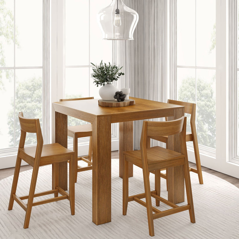 Sunlit modern Scandinavian wooden dining table with four oak chairs, pendant light and vase centerpiece by large windows