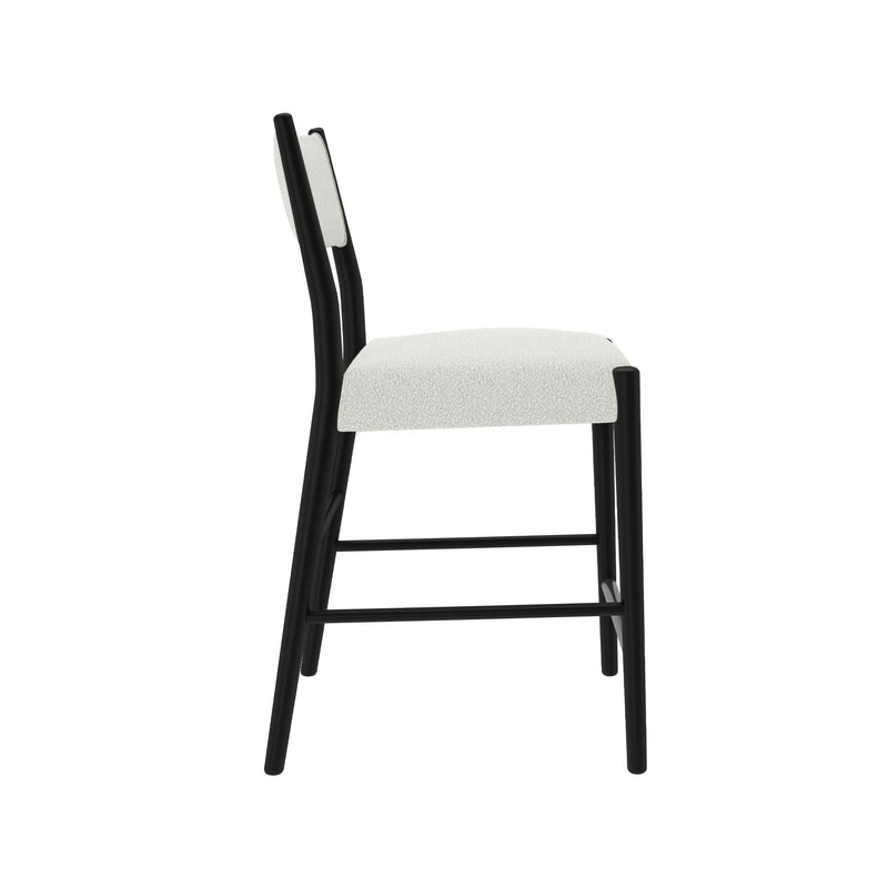 Side view of modern black wood-frame chair with white upholstered seat and backrest on a white background, minimalist dining or counter stool.