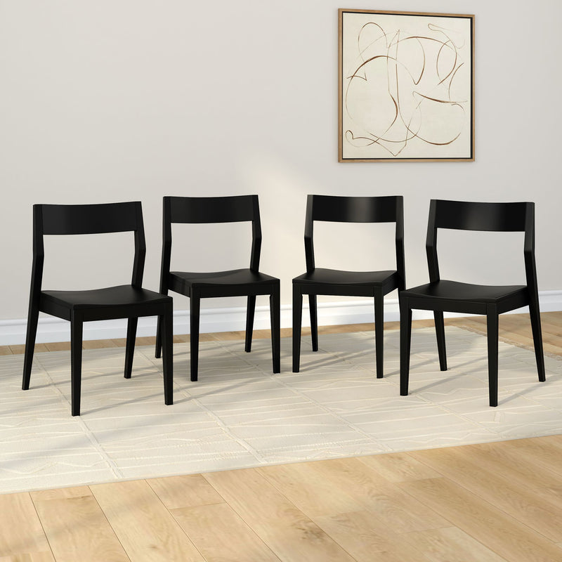 Four modern black dining chairs in a minimalistic room with a light-colored rug and abstract wall art.