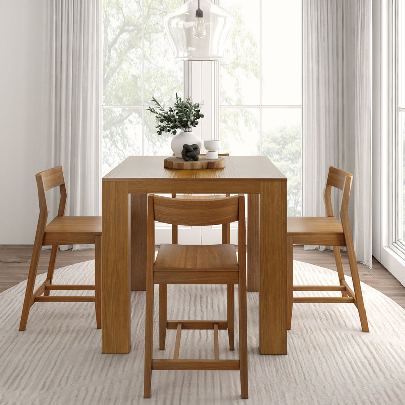 Minimalist dining room with wooden table and chairs, modern lighting, and neutral decor in a bright, airy space.