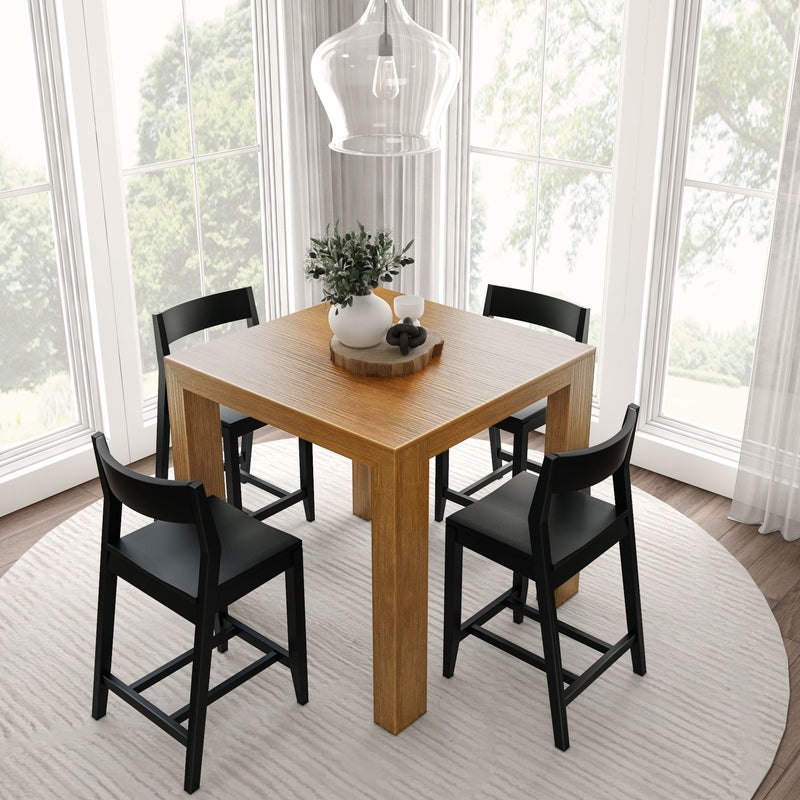 Modern dining area featuring a wooden table with black chairs in a sunlit room.
