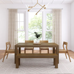 Minimalist dining room with a modern wooden table, chairs, and geometric chandelier.