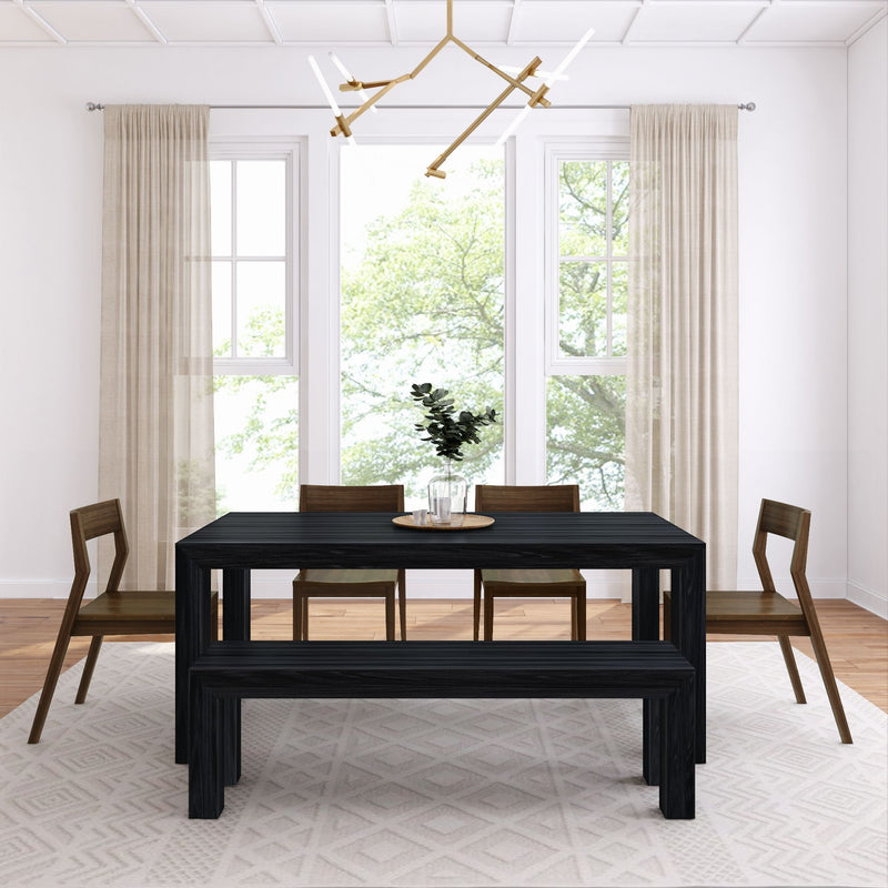 Minimalist modern dining room with black wood table and bench, mid-century wooden chairs, large windows with sheer beige curtains, geometric area rug, and brass linear chandelier