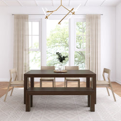 Modern dining room with wooden table, chairs, and minimalistic decor in a bright setting.