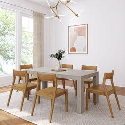 Modern dining room with wooden table and chairs, abstract wall art, and geometric chandelier.
