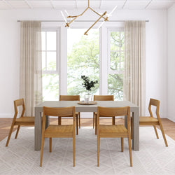 Modern dining room with wooden chairs and a contemporary chandelier, featuring large windows and minimalistic decor elements.