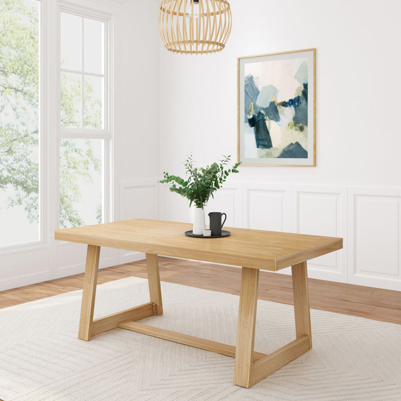 Modern dining room with natural wood table and minimalist decor, featuring a potted plant and stylish wall art, perfect for contemporary home design.