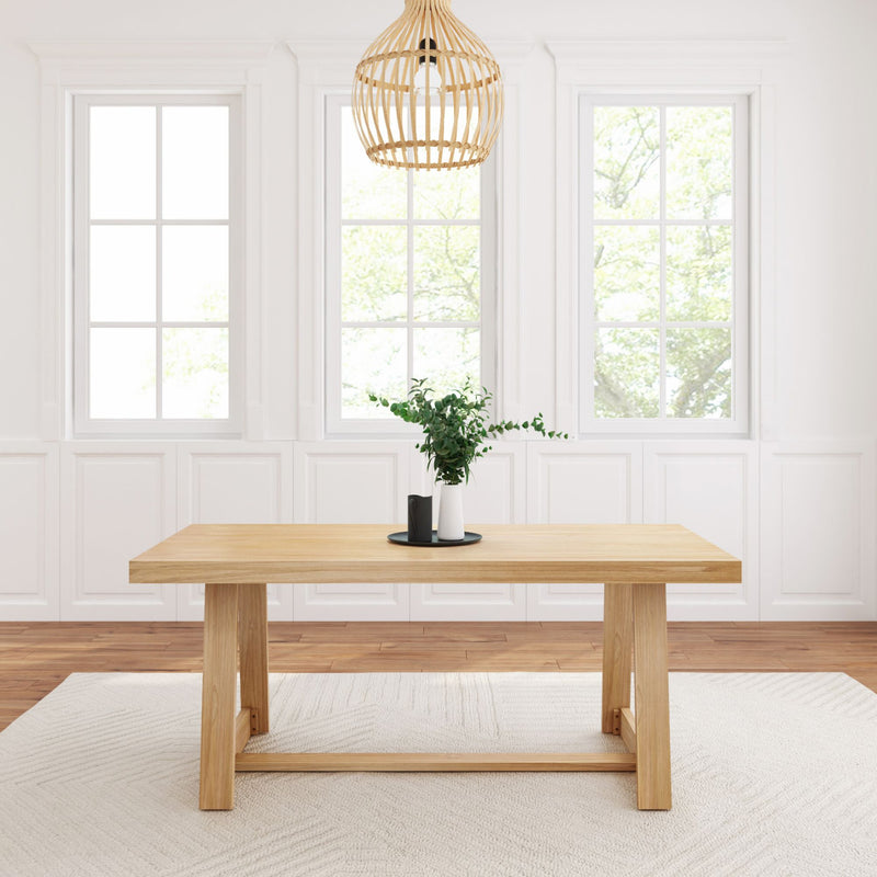 Modern dining room with wooden table, stylish pendant light, and large windows for natural lighting.