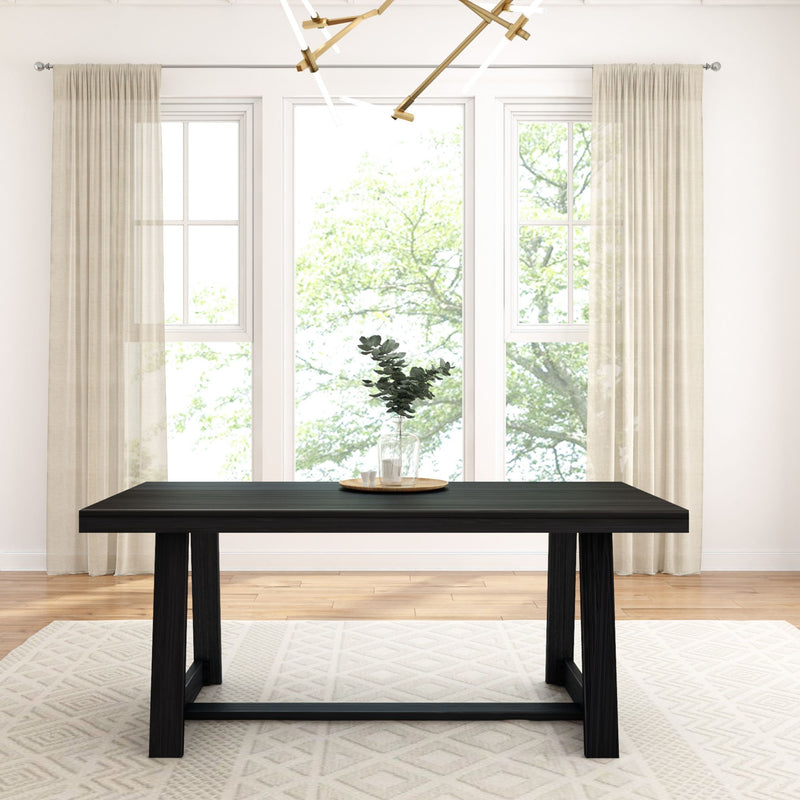 Sleek modern dining table with dark wood finish in bright room with large windows and neutral curtains.