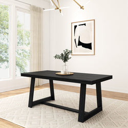 Modern dining room with sleek black table, geometric chandelier, framed abstract art, and glass vase centerpieces.
