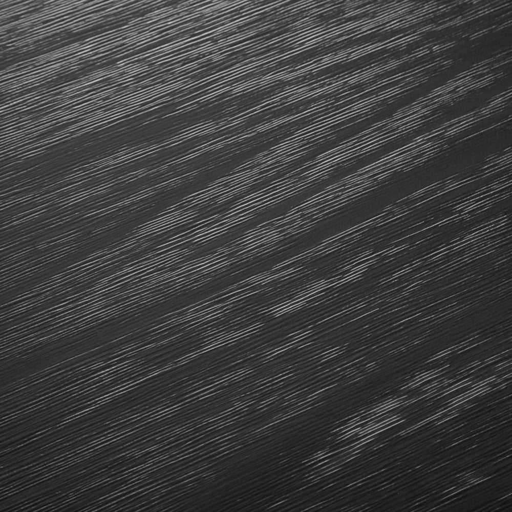 Close-up of black wooden texture with prominent grain patterns.